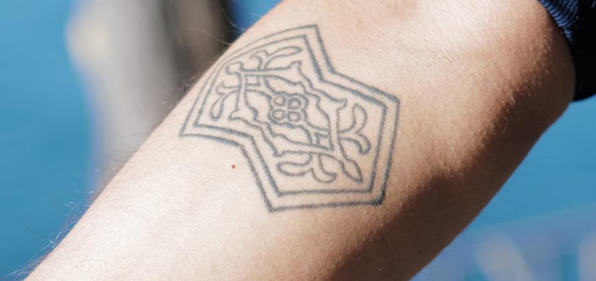 Athreya’s right arm bears a tattoo of his favorite translation surface — a double pentagon. (Radhika Govindrajan)