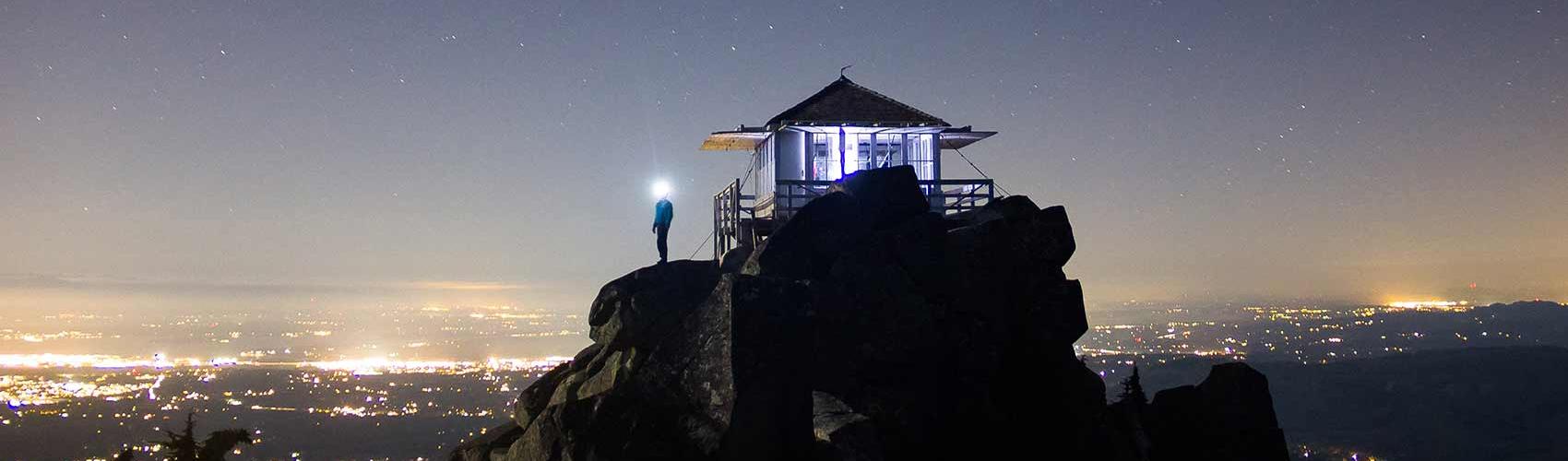 Mountaintop lookout tower overlooking city lights